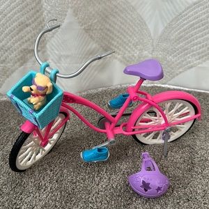 Barbie cruiser bike with purple helmet and dog in basket